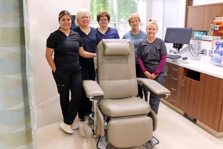 BVRMC Oncology Nurses standing around a newly purchased chemotherapy chair.